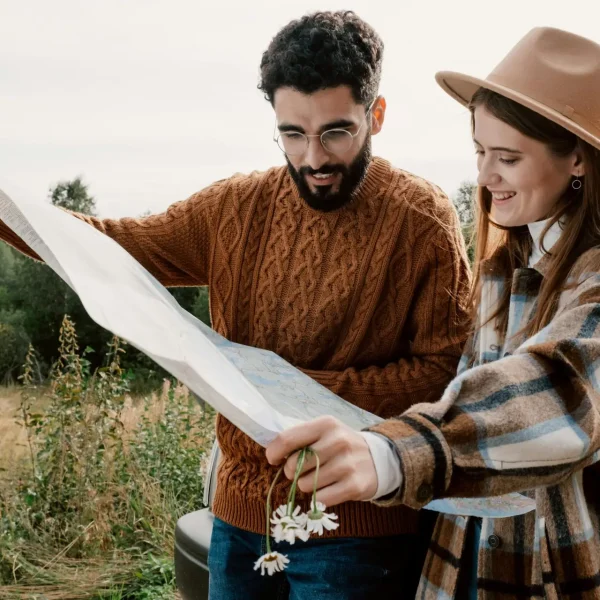 pexels-photo-5966303-5966303 A couple in cozy attire examining a map for their outdoor adventure.